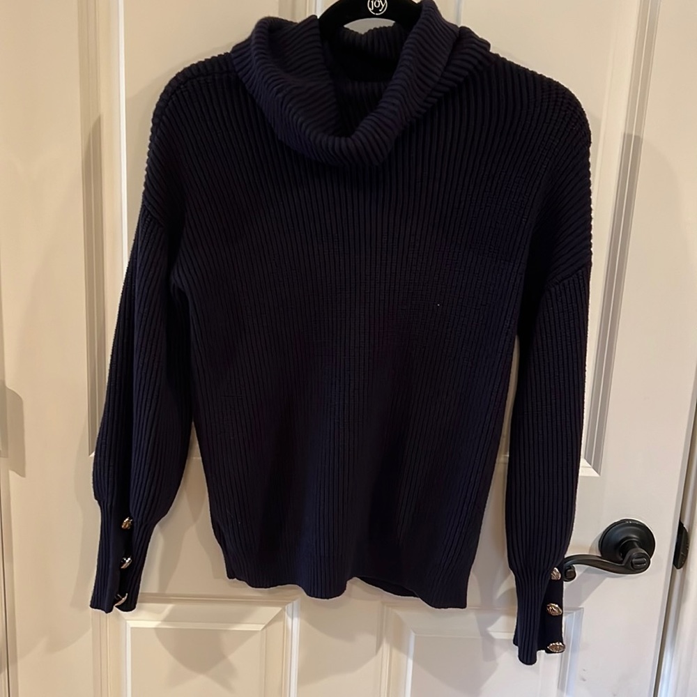 Navy blue sweater with puffy sleeve. Button sleeve